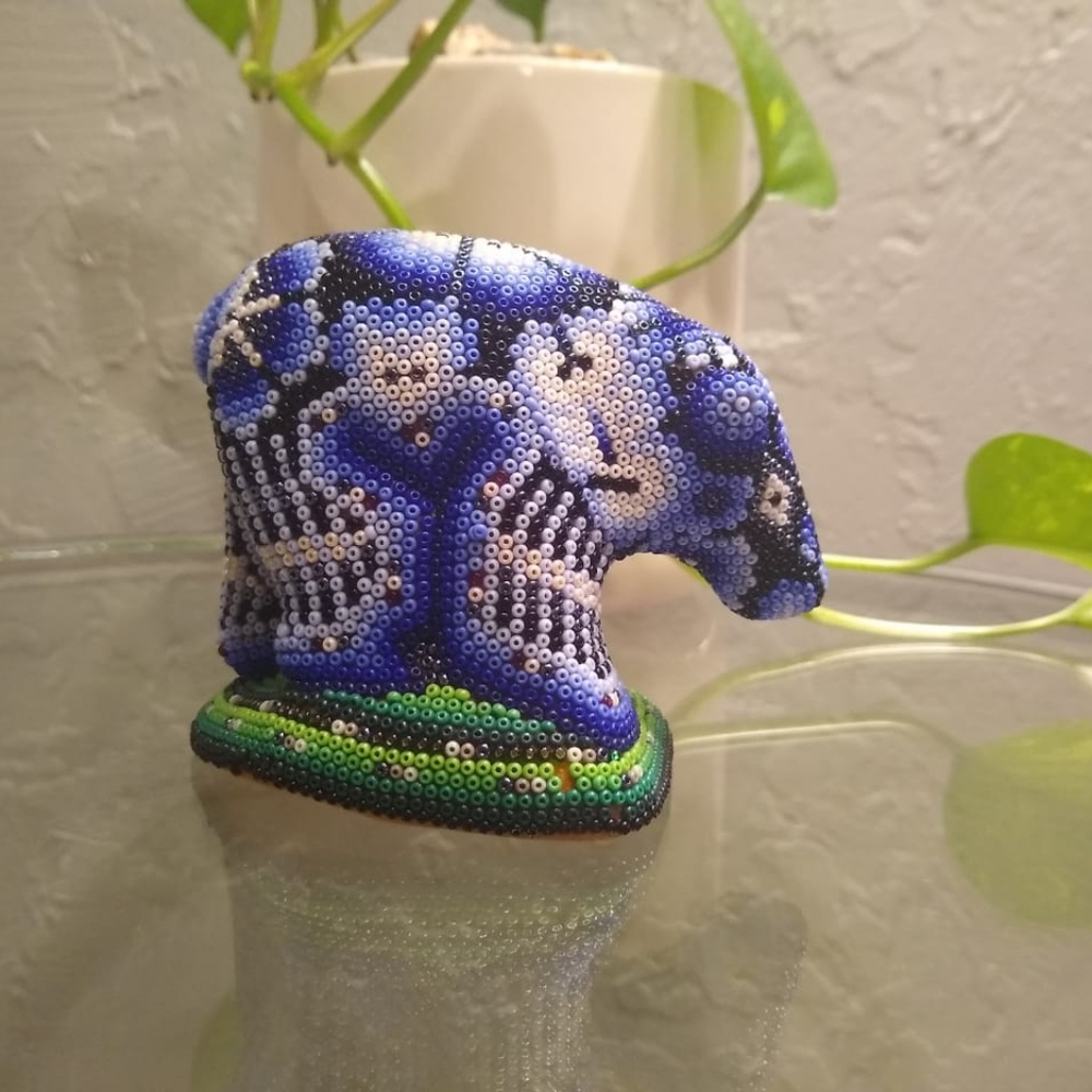 This is a wooden bear with beads